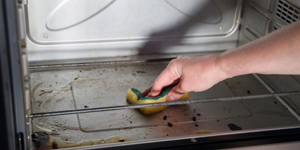 cleaning-the-oven-from-burnt-drops-with-a-sponge-2022-11-10-01-53-44-utc