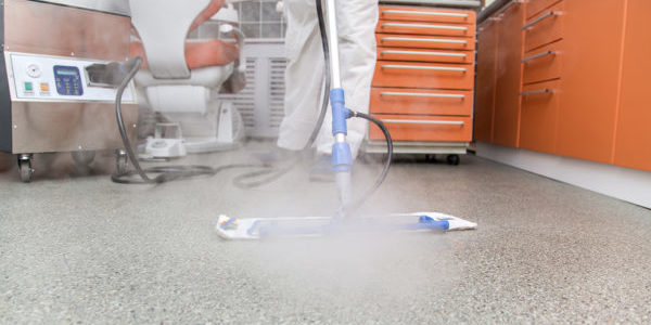 Young man cleans the floor in the dental office